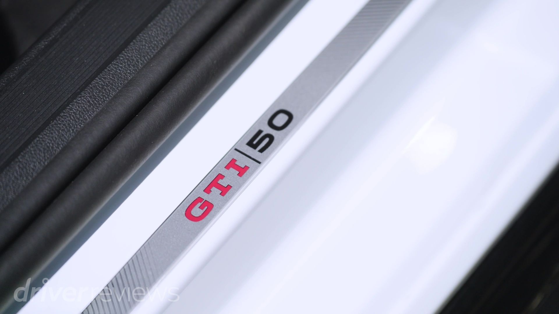 Golf GTI Edition 50 door sill badge reading "GTI 50" in red and black