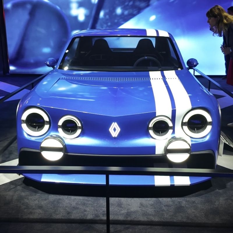 Blue Renault 8 Gordini Concept with a white stripe and six round headlights on the Renault stand at Paris Motor Show 2026, shown head-on