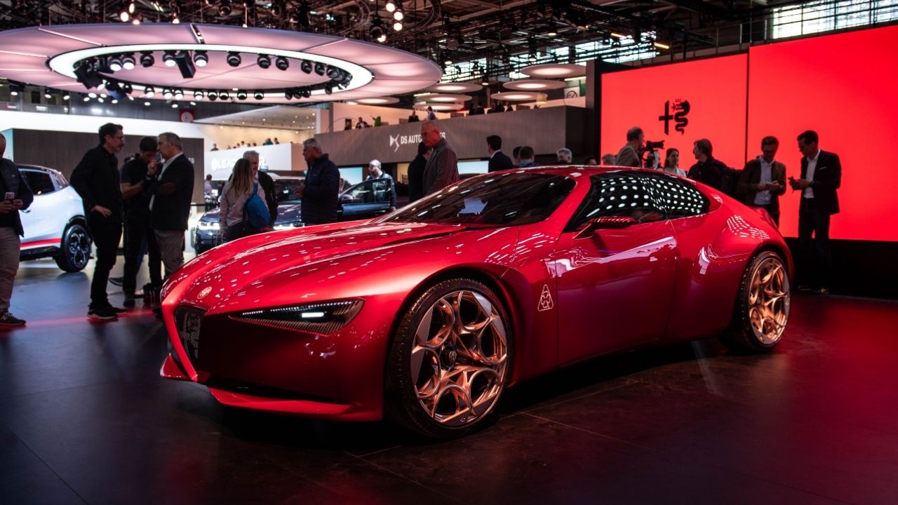 Red Alfa Romeo Cuorerosso concept with bronze wheels on the Alfa Romeo stand at Paris Motor Show 2026, viewed from the front three-quarter