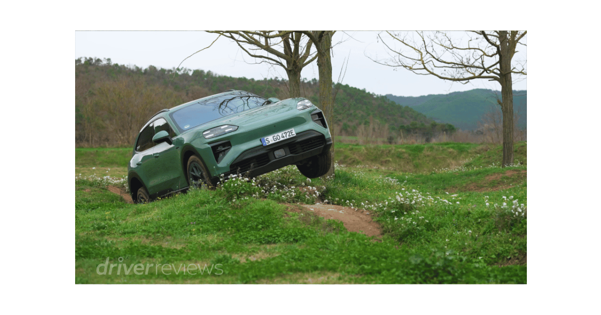 Porsche Cayenne Turbo Electric cresting an off-road bank during DriverReviews test