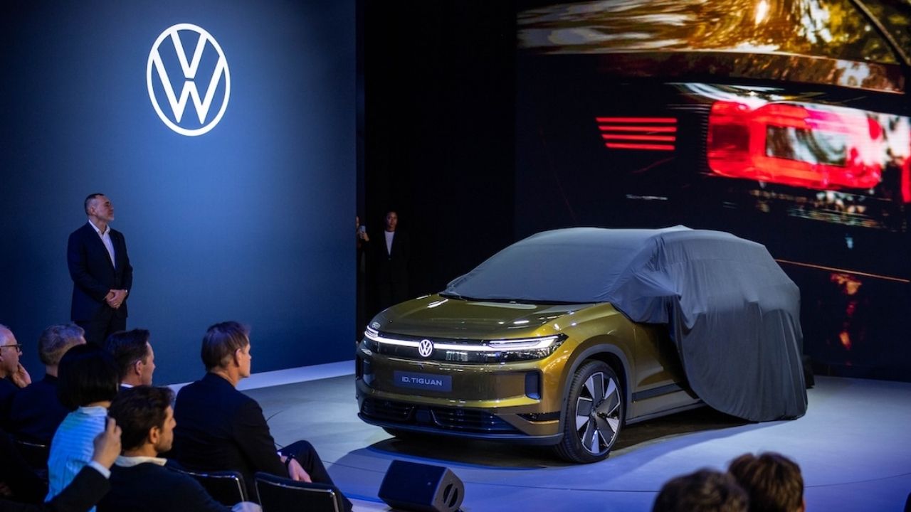 Olive green Volkswagen ID. Tiguan being unveiled on the Volkswagen stand at Paris Motor Show 2026, with its cover partly removed