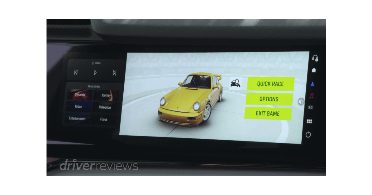 Porsche Cayenne Turbo Electric passenger display showing Porsche 911 racing game with Mood Modes panel