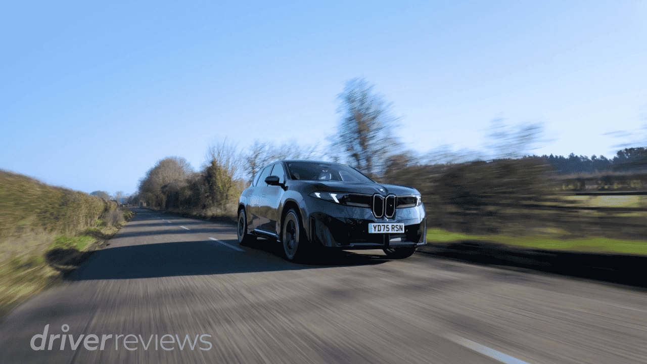 BMW iX3 50 xDrive on country road in motion during DriverReviews test
