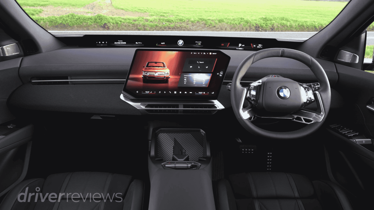 BMW iX3 interior with pillar-to-pillar Panoramic iDrive screen showing BMW operating system X