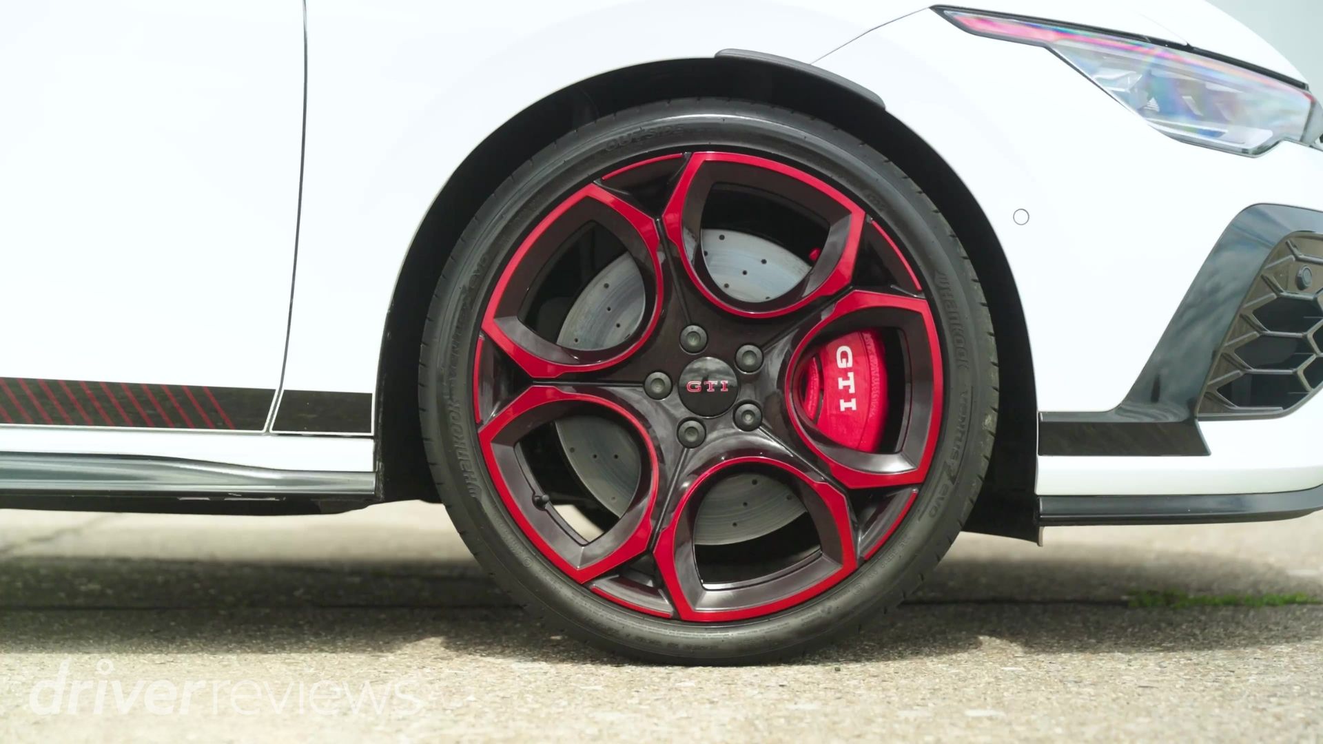Volkswagen Golf GTI Edition 50's red-tinged 19-inch alloy wheel with GTI-branded brake caliper and Hankook tyre