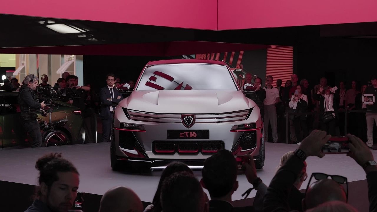Silver Peugeot E-T16 Concept with red accents on the Peugeot stand at Paris Motor Show 2026, shown head-on in front of a press crowd