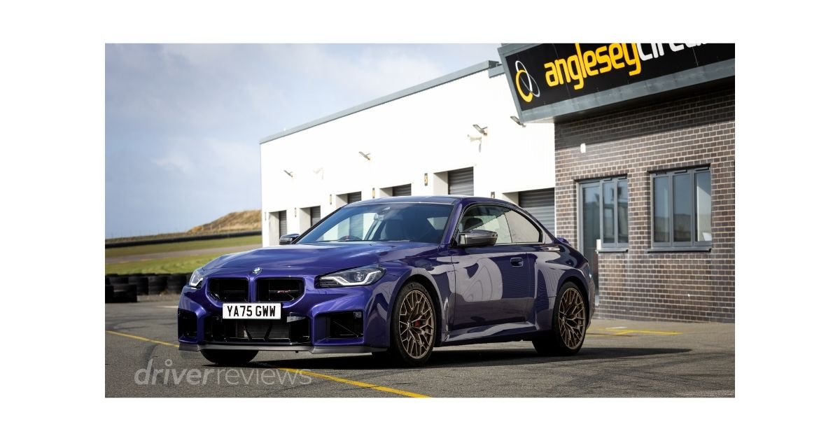 BMW M2 CS front three-quarter view in San Marino Blue at Anglesey Circuit with gold Bronze alloy wheels