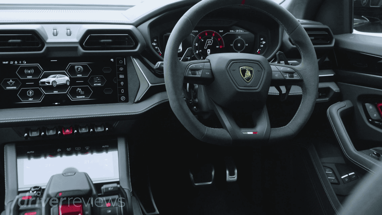 Lamborghini Urus SE interior showing steering wheel, dual screens and Tamburo control centre during DriverReviews test