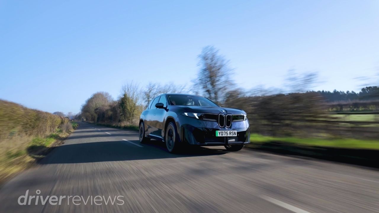 BMW iX3 50 xDrive on country road in motion during DriverReviews test