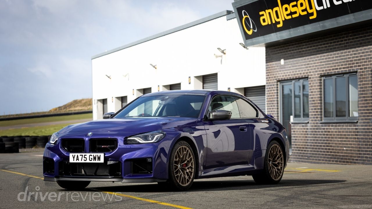 BMW M2 CS front three-quarter view in San Marino Blue at Anglesey Circuit with gold Bronze alloy wheels