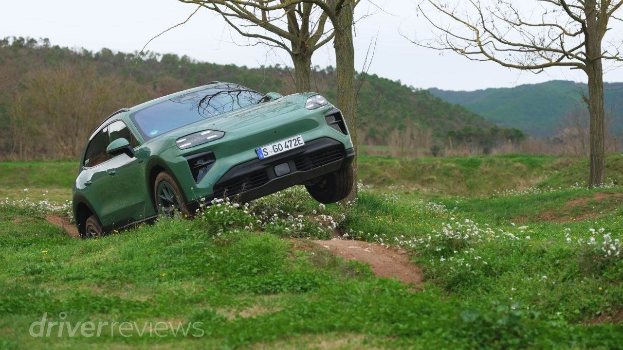 Porsche Cayenne Turbo Electric cresting an off-road bank during DriverReviews test