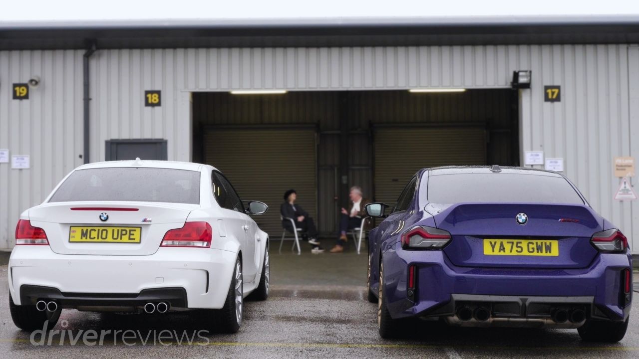 BMW 1M and BMW M2 CS rear view side by side at circuit with Vicki Butler-Henderson and Tiff Needell in background
