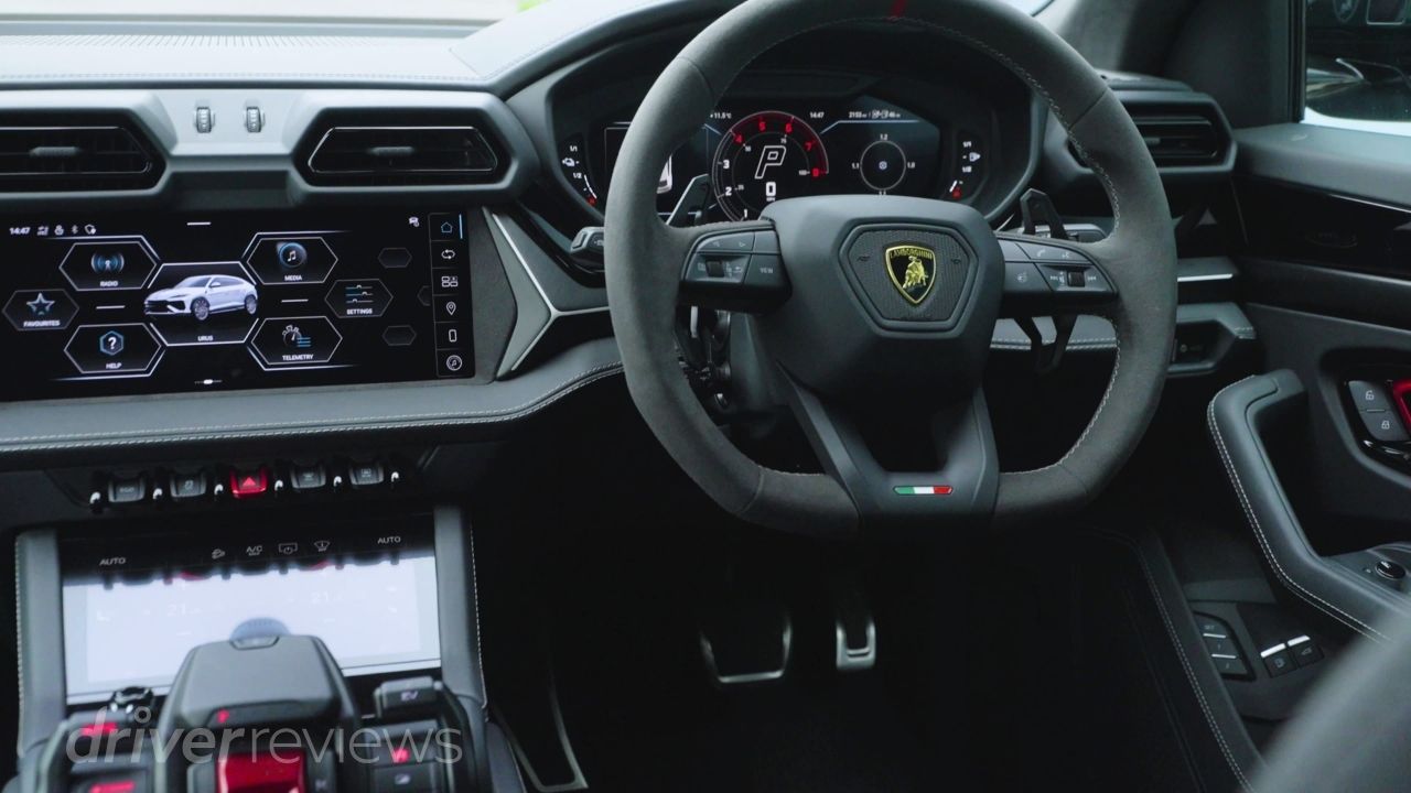 Lamborghini Urus SE interior showing steering wheel, dual screens and Tamburo control centre during DriverReviews test
