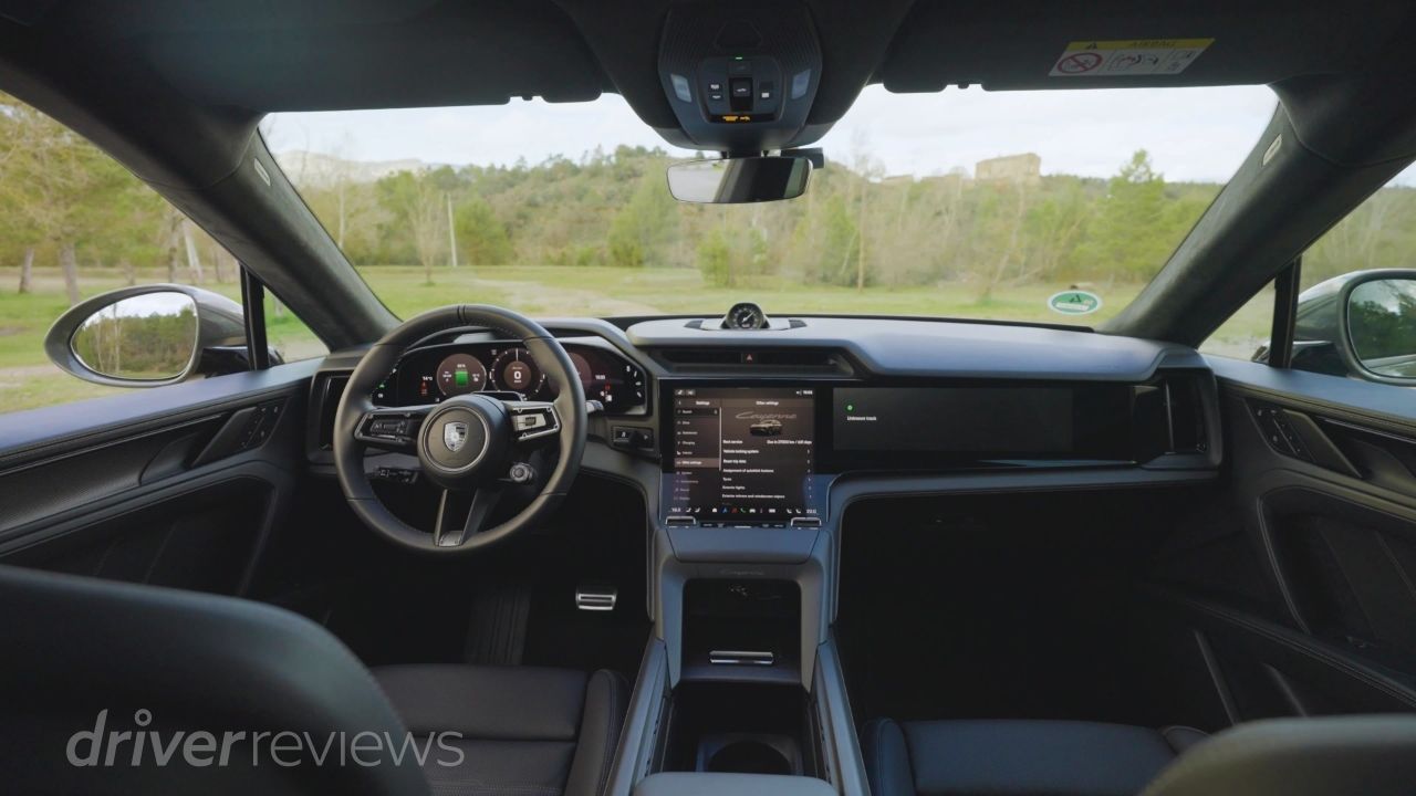 Porsche Cayenne Turbo Electric interior with Flow Display curved OLED screen and Porsche steering wheel in DriverReviews test