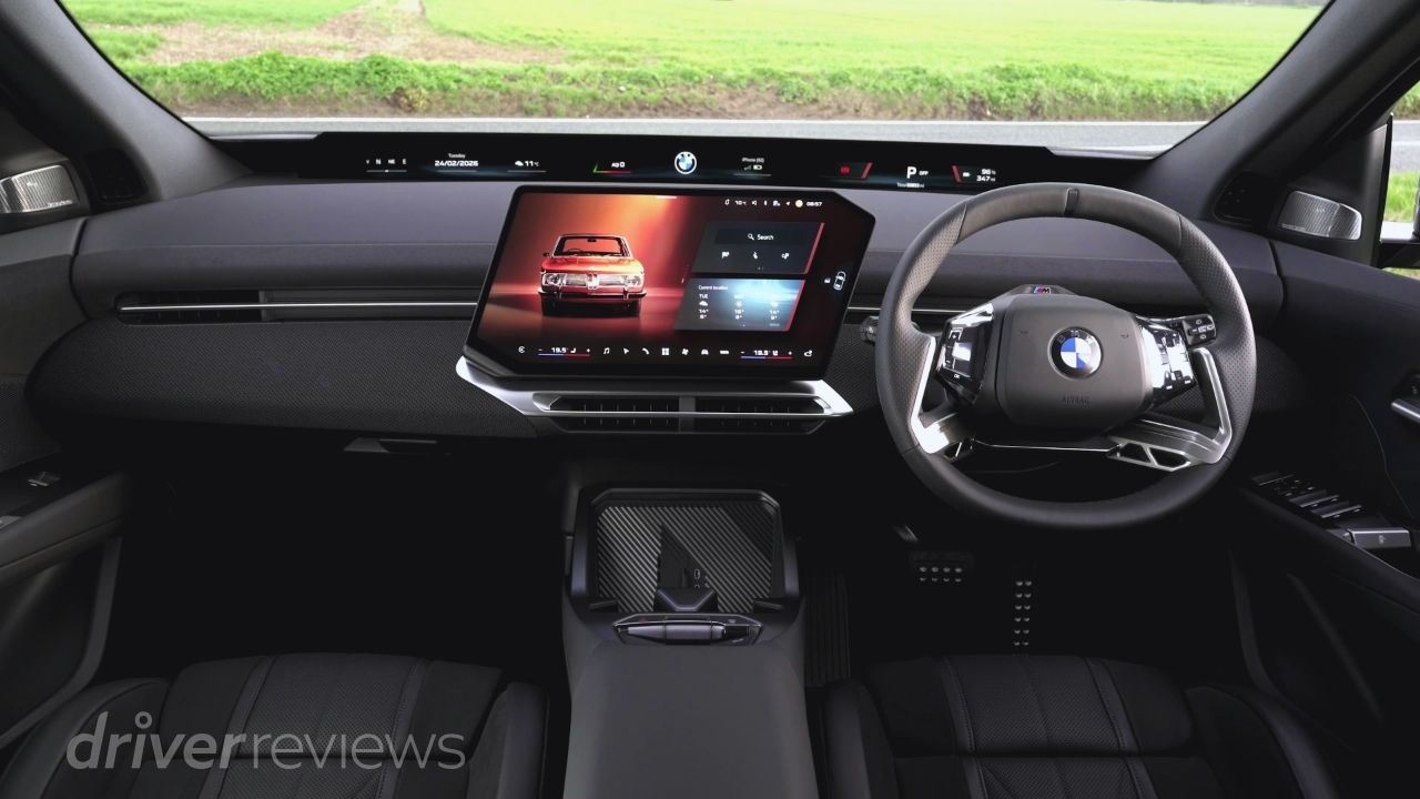 BMW iX3 interior with pillar-to-pillar Panoramic iDrive screen showing BMW operating system X