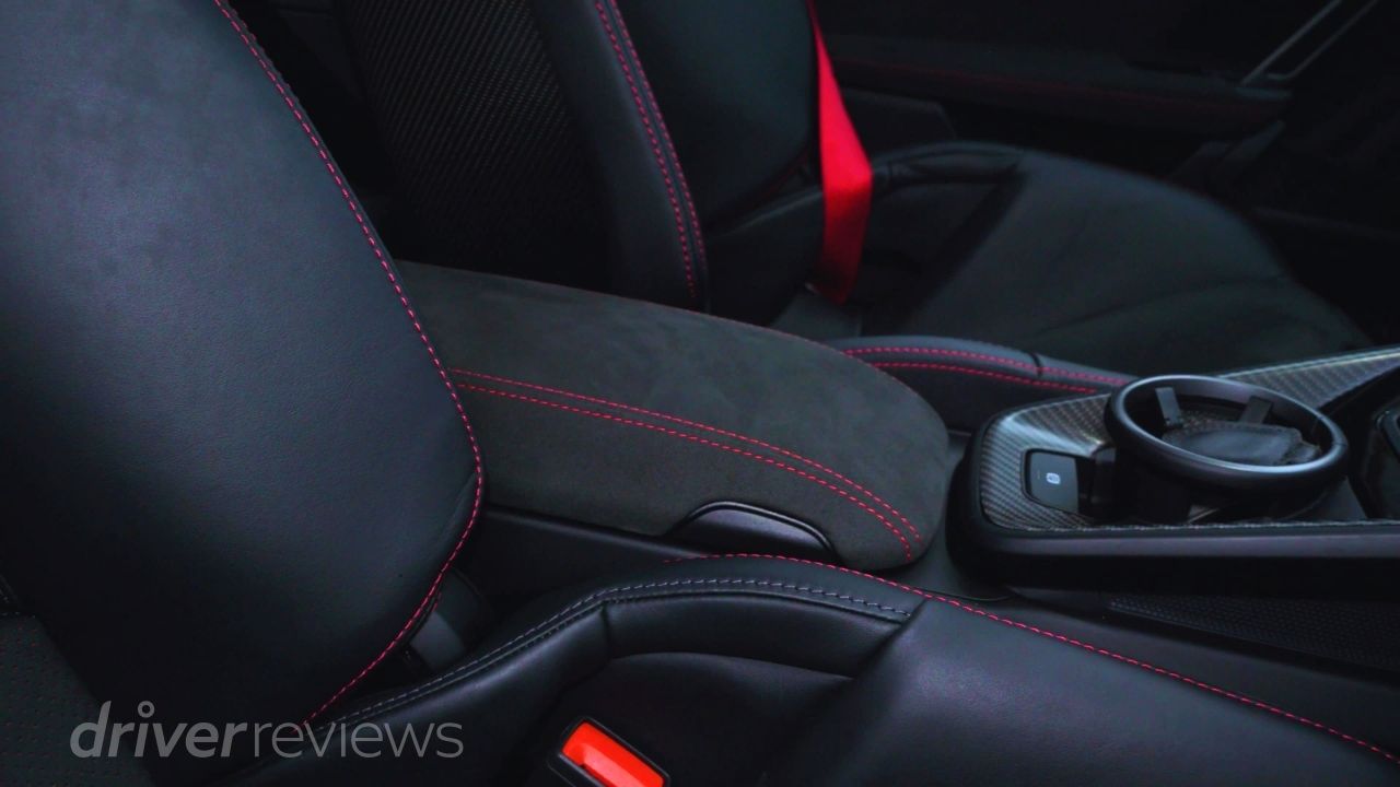 Porsche 911 GT3 992.2 carbon bucket seat detail with red stitching during DriverReviews test