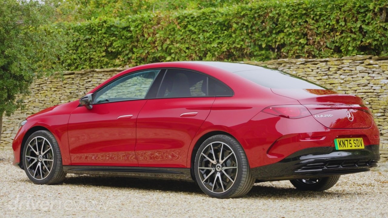 Rear three-quarter view of the Mercedes-Benz CLA 250+ Electric showing its sloping roofline and full-width LED light bar