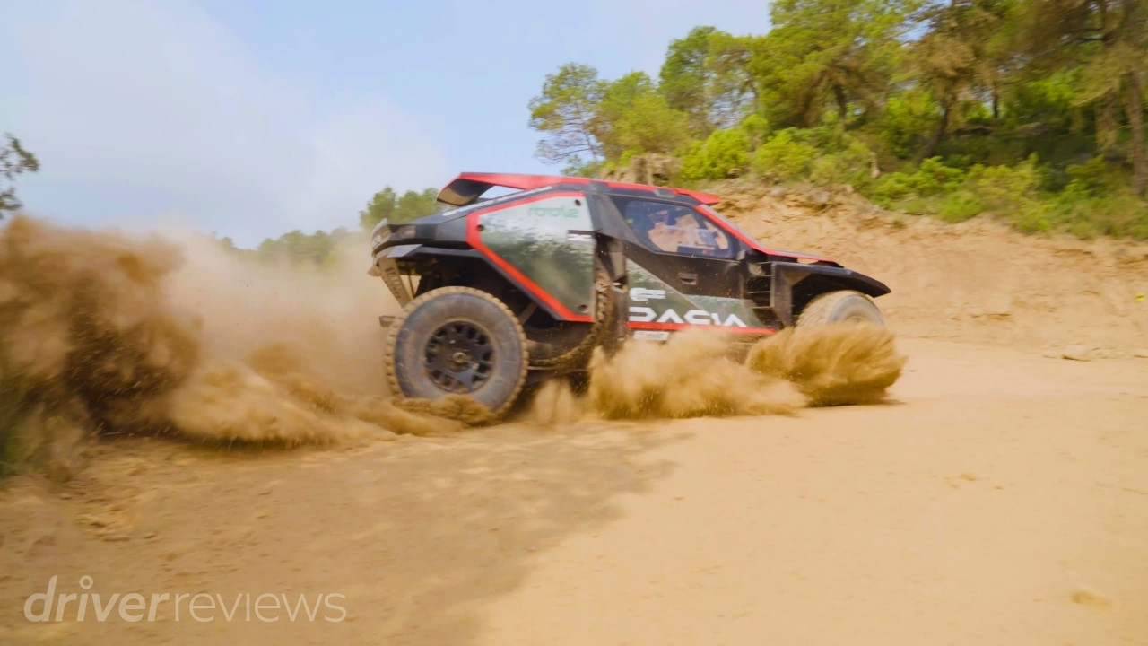 Dacia Sandrider kicking up dust while driving at speed on an off-road rally raid course in Spain