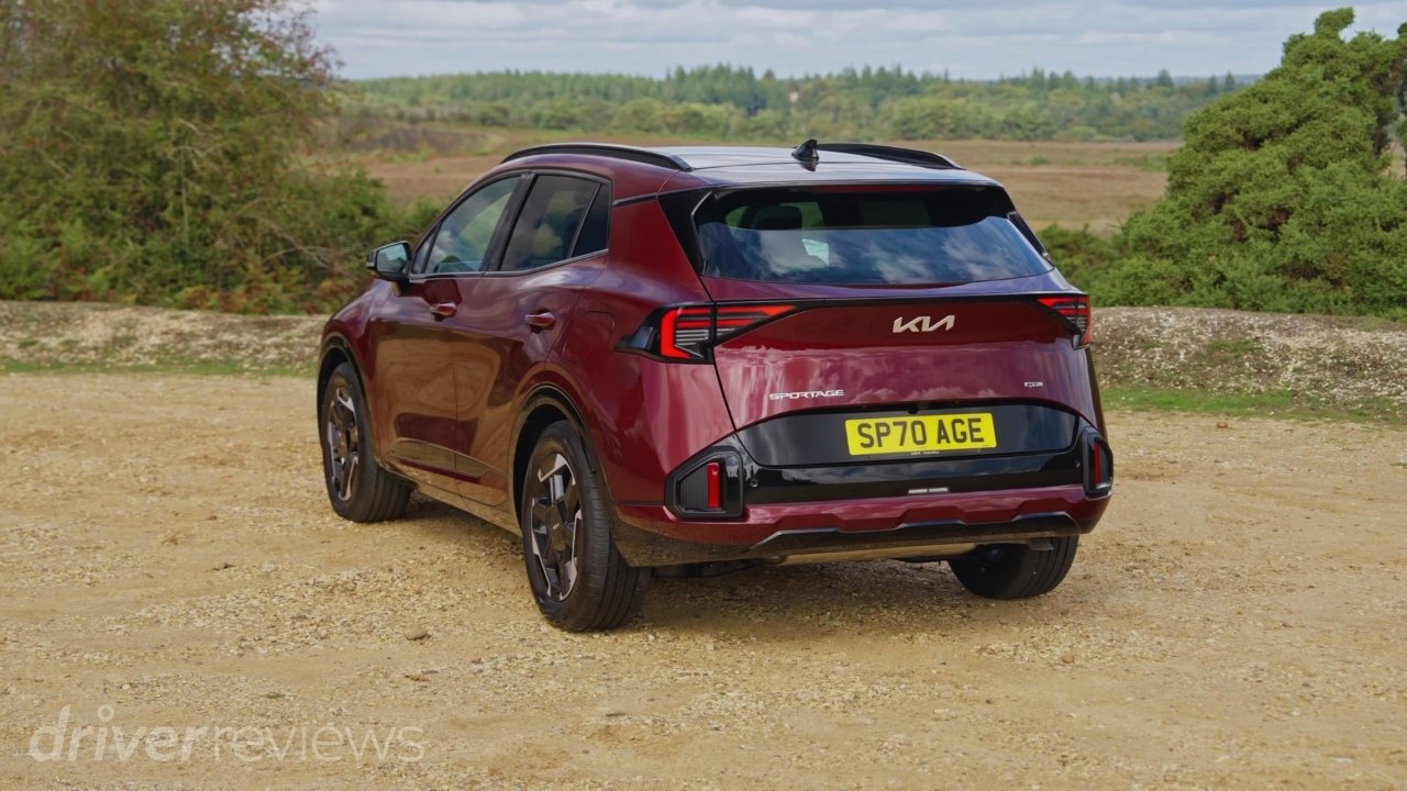 Red Kia Sportage GT-Line S rear three-quarter view parked on gravel