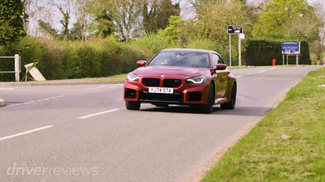 Fire Red BMW M2 G87 driving on the road