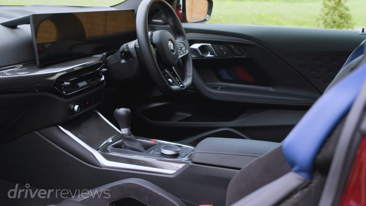 BMW M2 G87 interior with six-speed manual gear lever and carbon trim