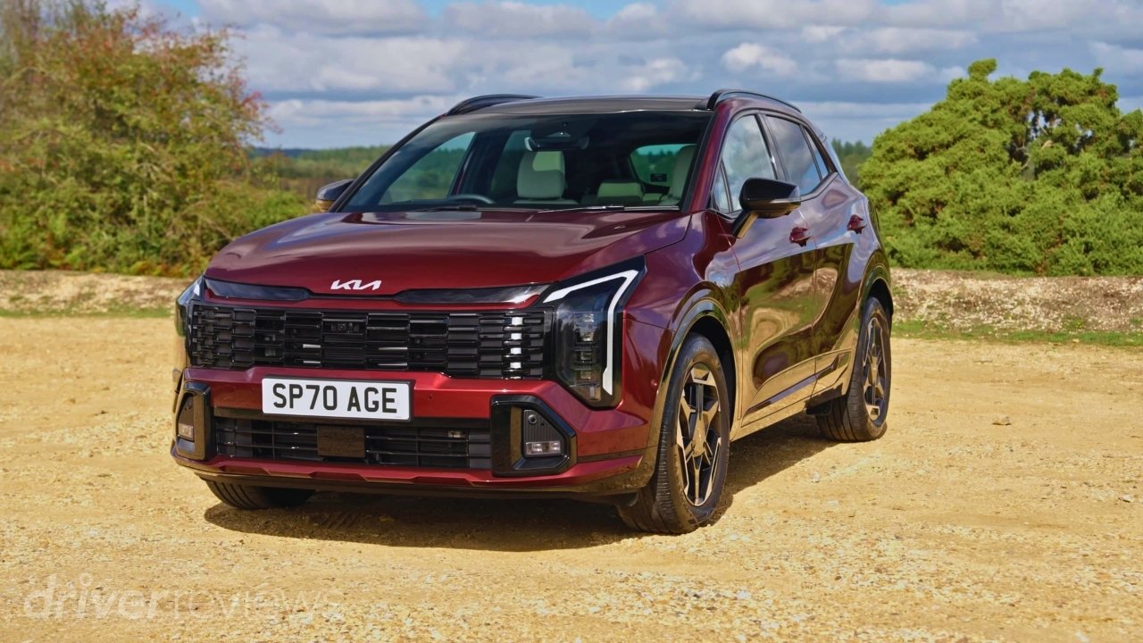 Red Kia Sportage GT-Line S front three-quarter view parked on gravel