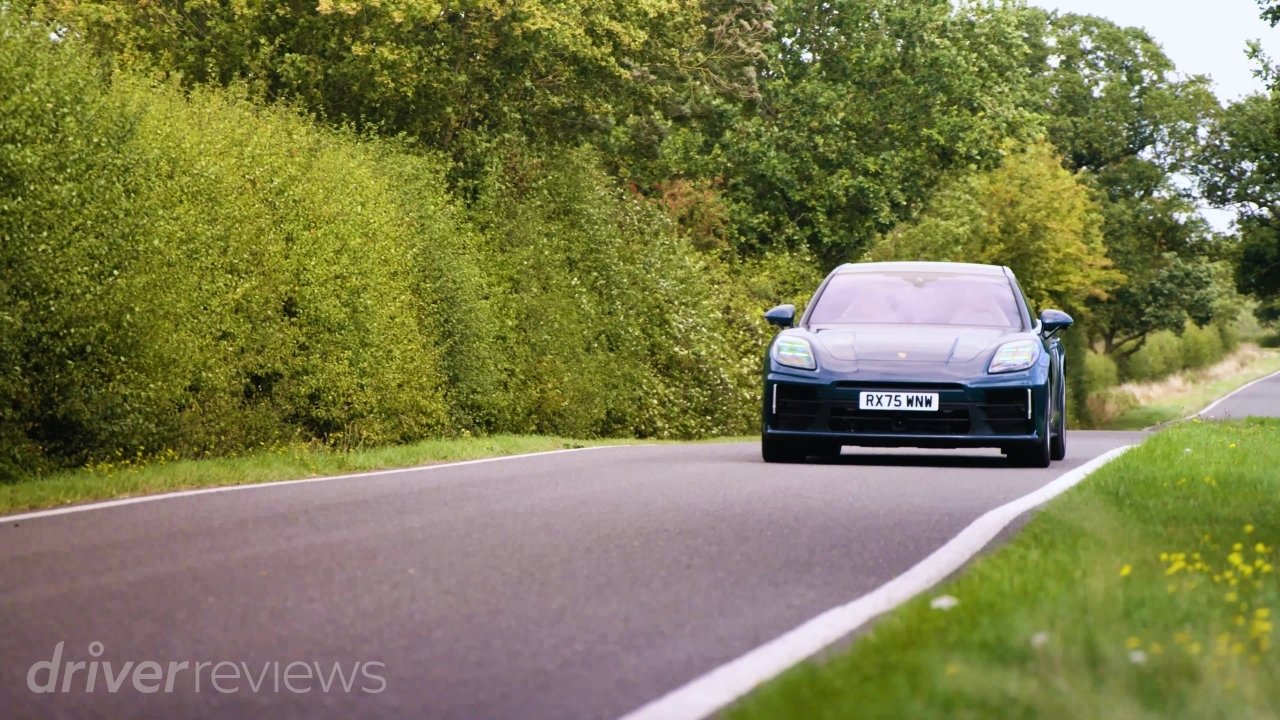 Montego Blue Metallic Porsche Panamera 4 E-Hybrid driving on a country road in front view